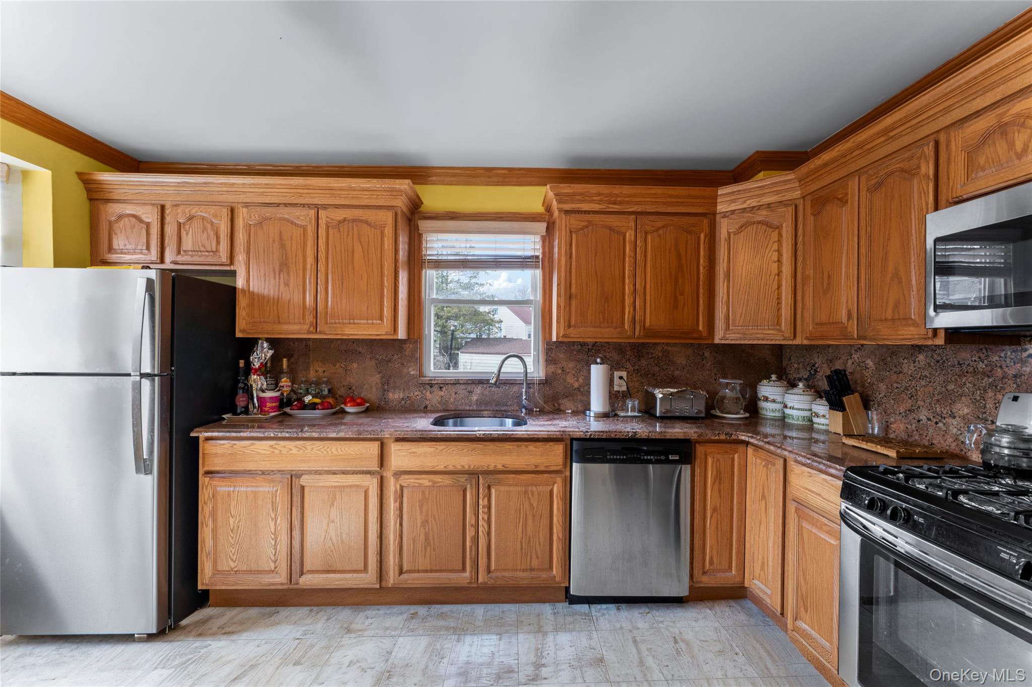 18 Butler Place Yonkers, NY 10710 - Photo 14 of 46 a kitchen with stainless steel appliances granite countertop a stove a sink dishwasher and a refrigerator