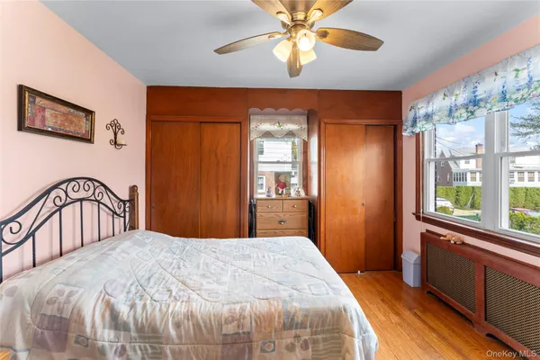 a bedroom with a large bed and a window