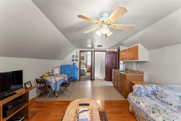 a bedroom with furniture and a flat screen tv