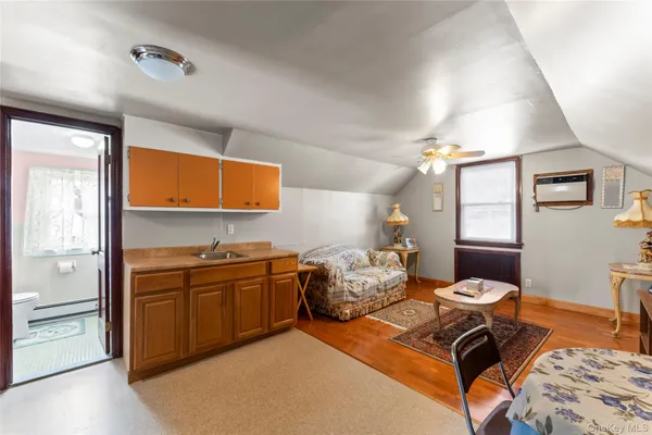 a kitchen with stainless steel appliances granite countertop a stove a sink dishwasher and a dining table with wooden cabinet