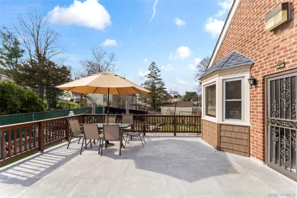 a patio with a patio table and chairs