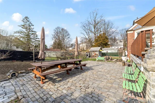 a front view of a house with a yard fire pit and outdoor seating
