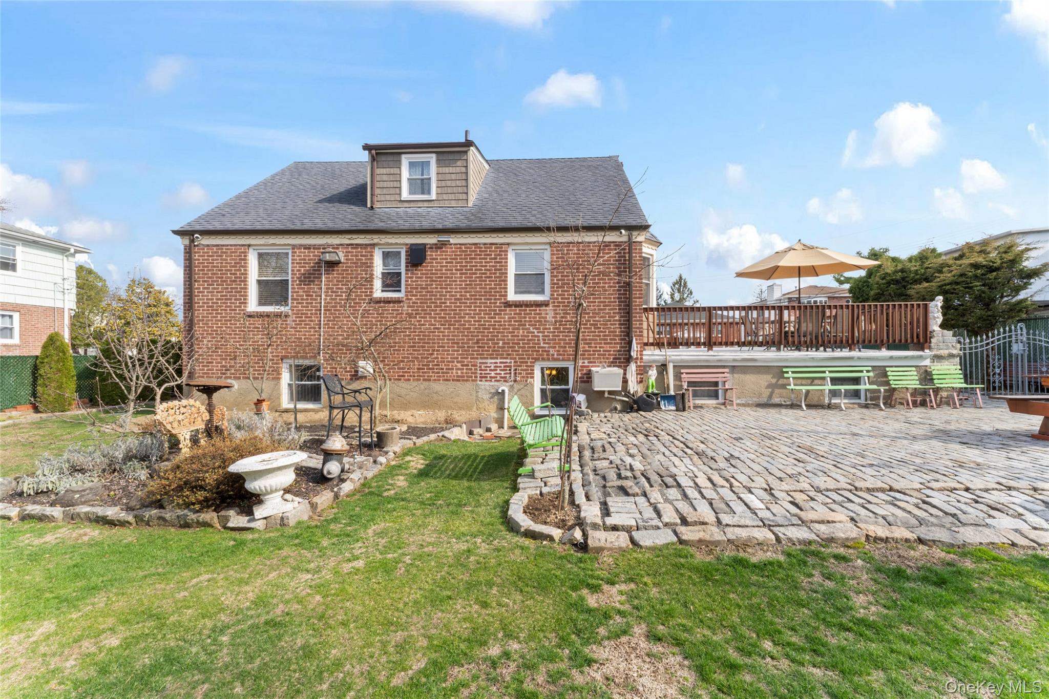 18 Butler Place Yonkers, NY 10710 - Photo 42 of 46 a front view of a house with a yard fire pit and outdoor seating