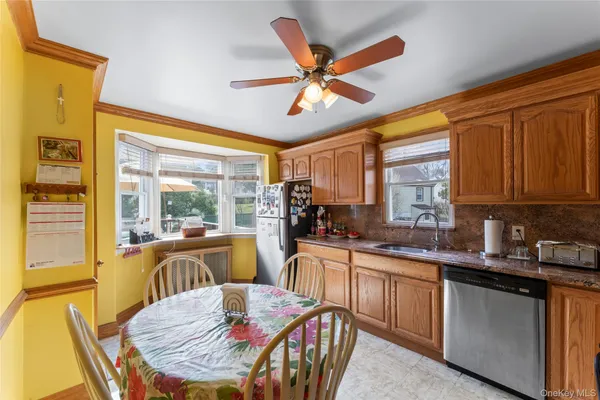 a kitchen that has a table chairs in it and wooden floors