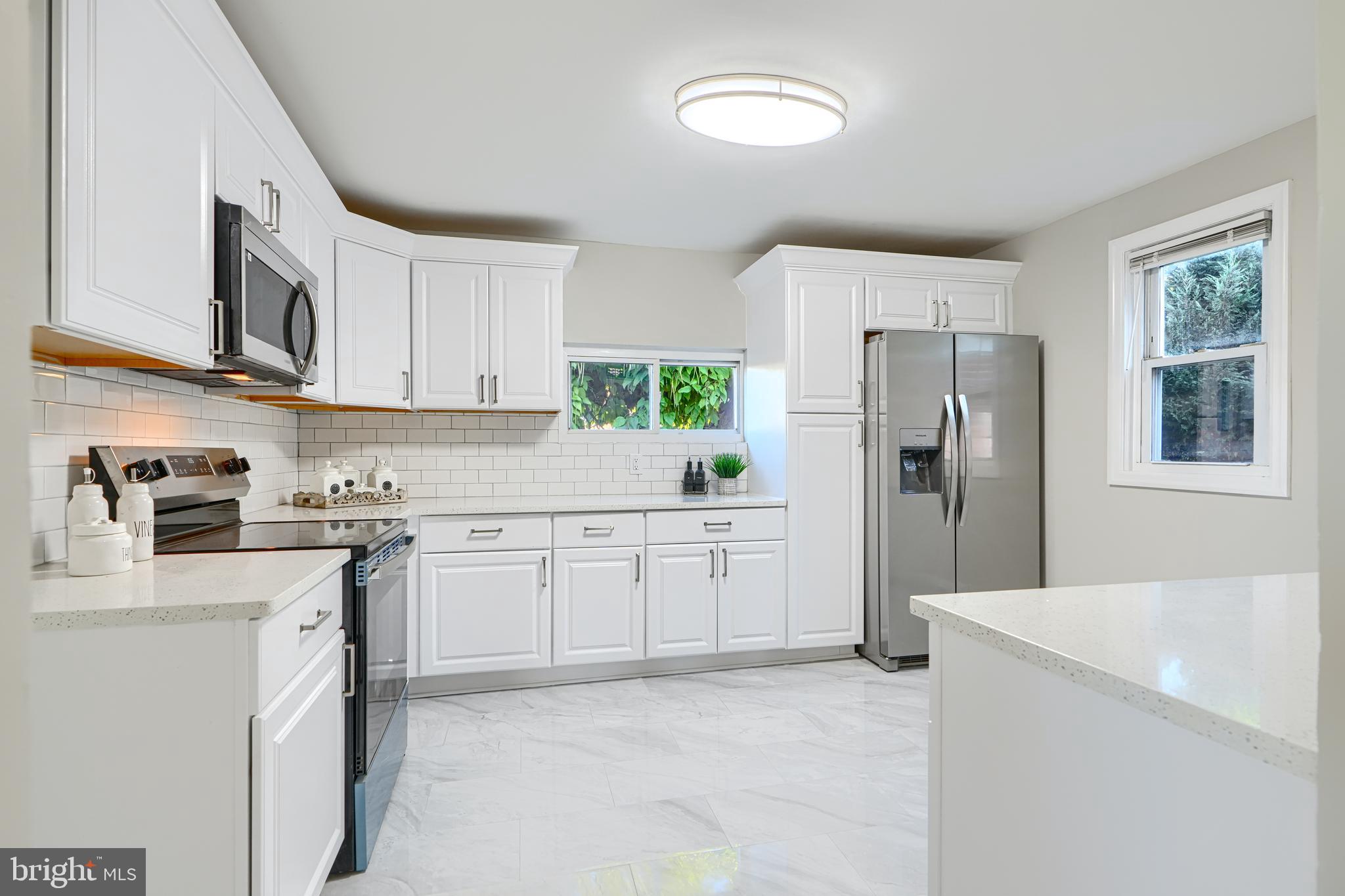 a kitchen with a refrigerator stove and sink