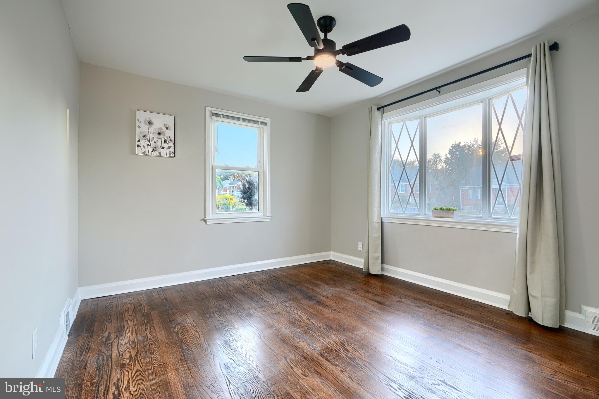 3515 Rhom Road Gwynn Oak, MD 21207 - Photo 15 of 36 an empty room with wooden floor fan and windows