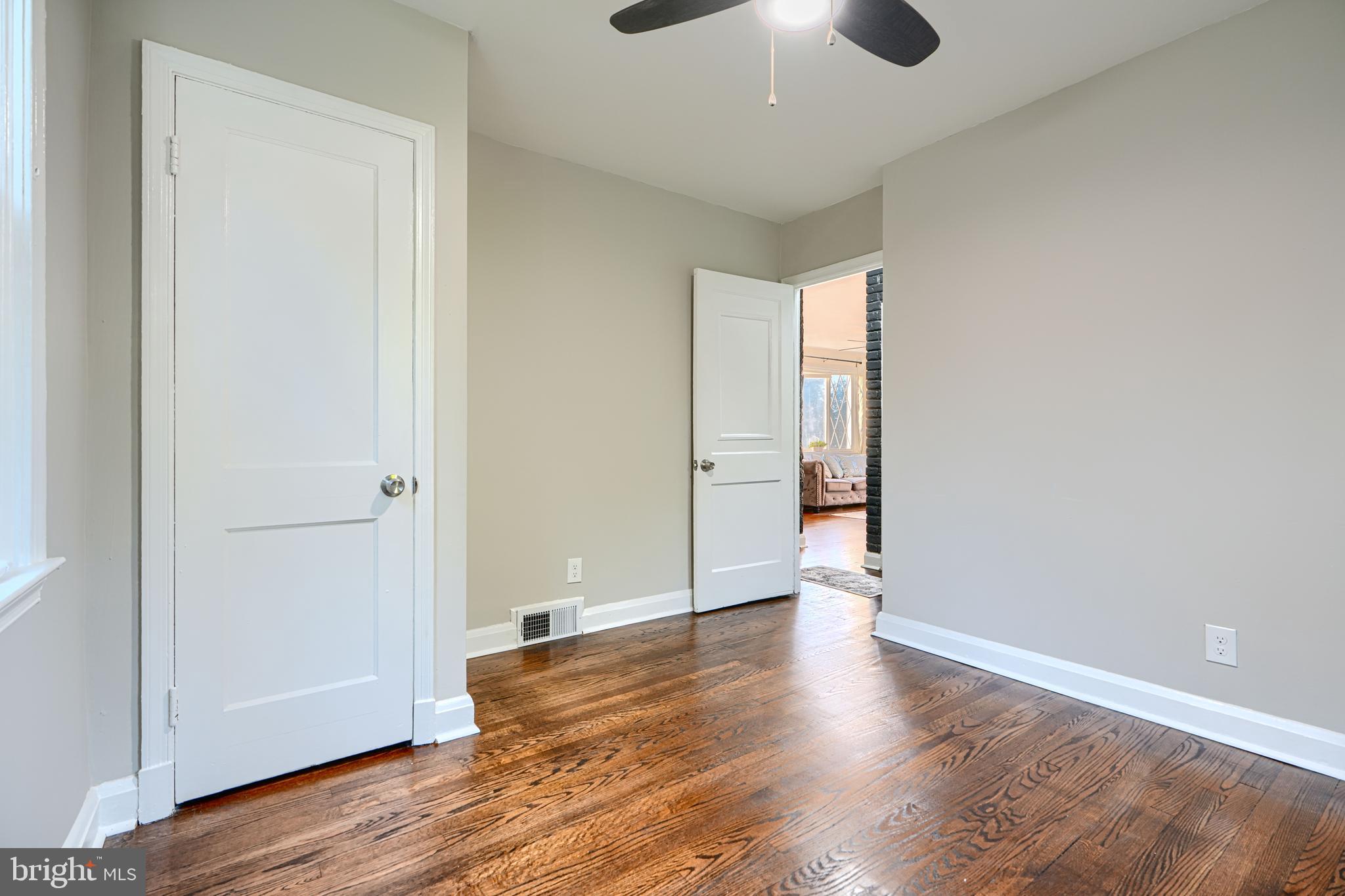 3515 Rhom Road Gwynn Oak, MD 21207 - Photo 19 of 36 an empty room with wooden floor and windows