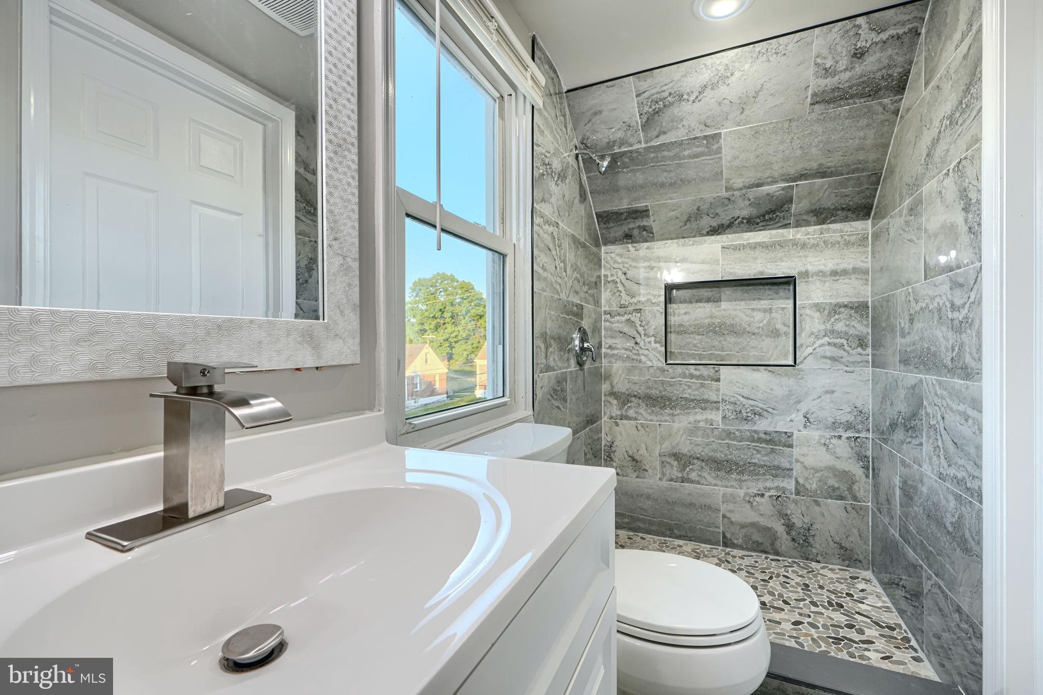 3515 Rhom Road Gwynn Oak, MD 21207 - Photo 21 of 36 a bathroom with a sink a toilet and a shower