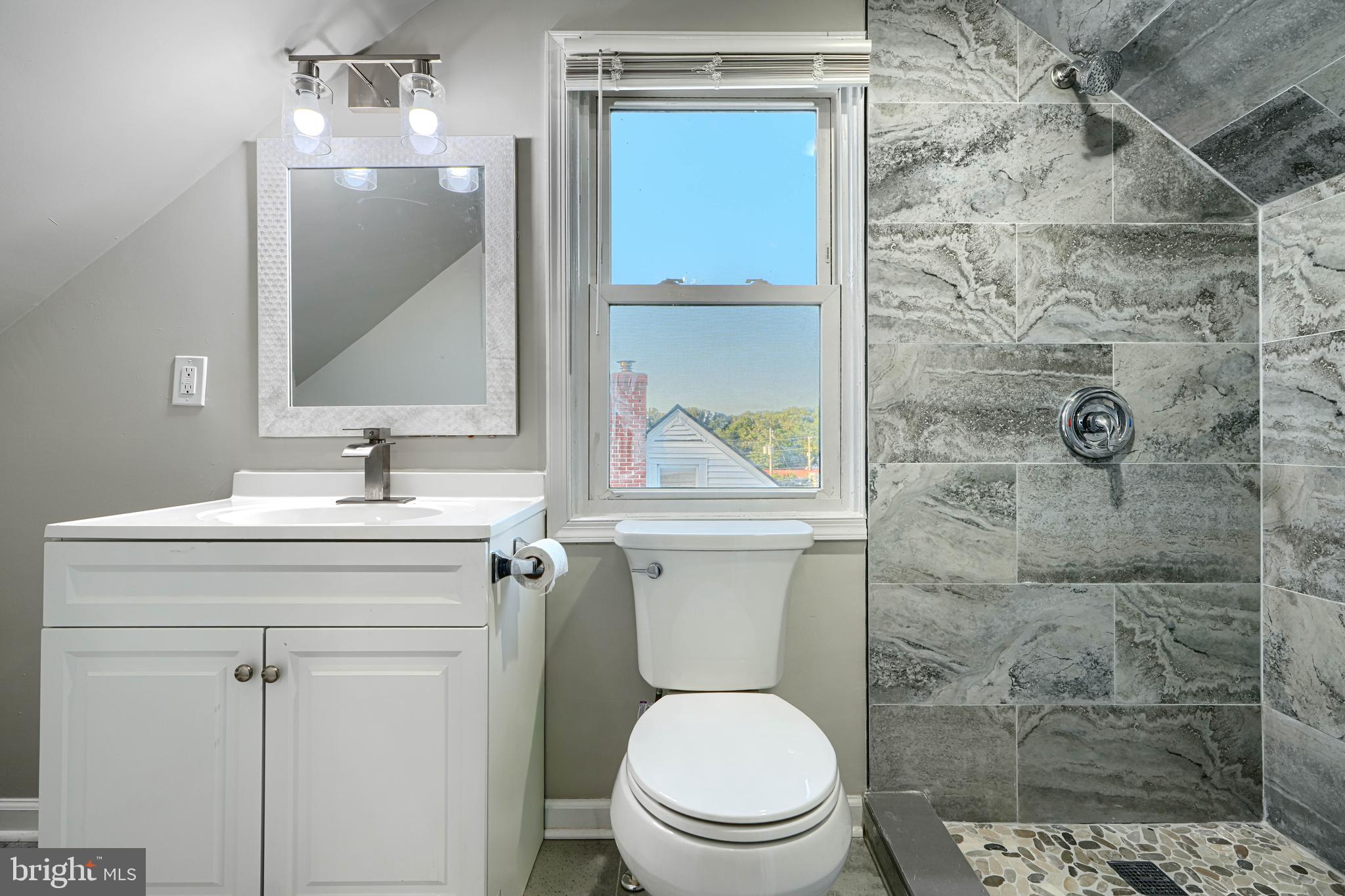 3515 Rhom Road Gwynn Oak, MD 21207 - Photo 23 of 36 a bathroom with a toilet sink vanity and mirror