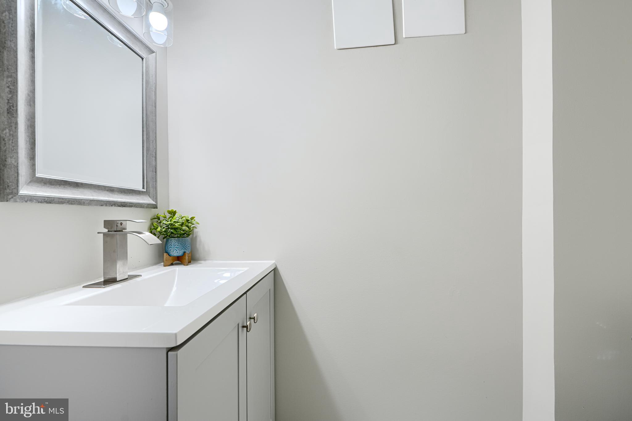 3515 Rhom Road Gwynn Oak, MD 21207 - Photo 29 of 36 a bathroom with a sink a vanity and a mirror