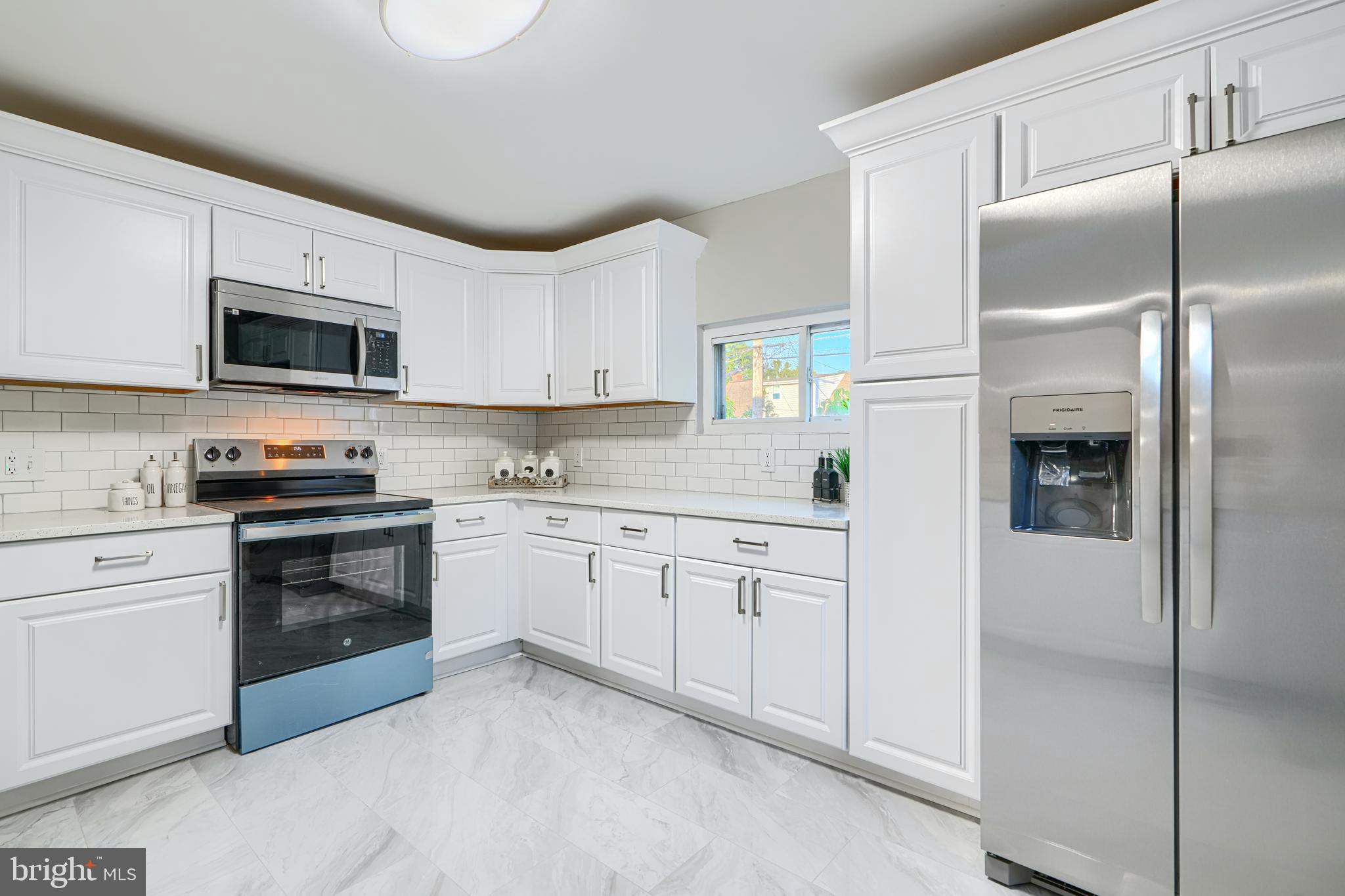 3515 Rhom Road Gwynn Oak, MD 21207 - Photo 6 of 36 a kitchen with cabinets stainless steel appliances and a window