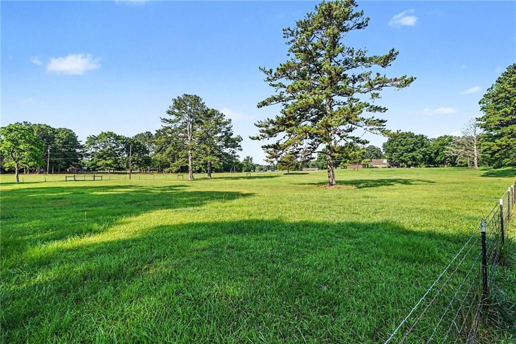 740 Smyrna Road Southwest Conyers, GA 30094 - Photo 26 of 27 a view of a grassy field with trees