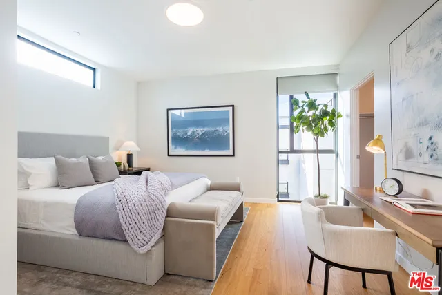 a living room with a bed furniture and a window