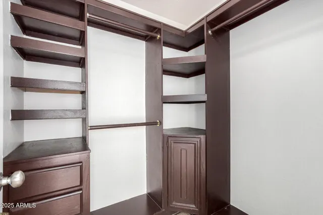 an empty room with fan and windows