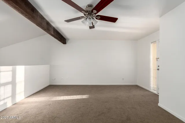a view of a livingroom with a ceiling fan and window