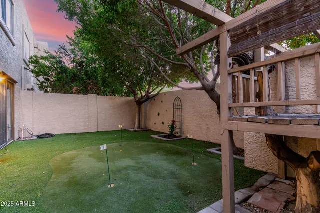 a view of a white house with a big yard