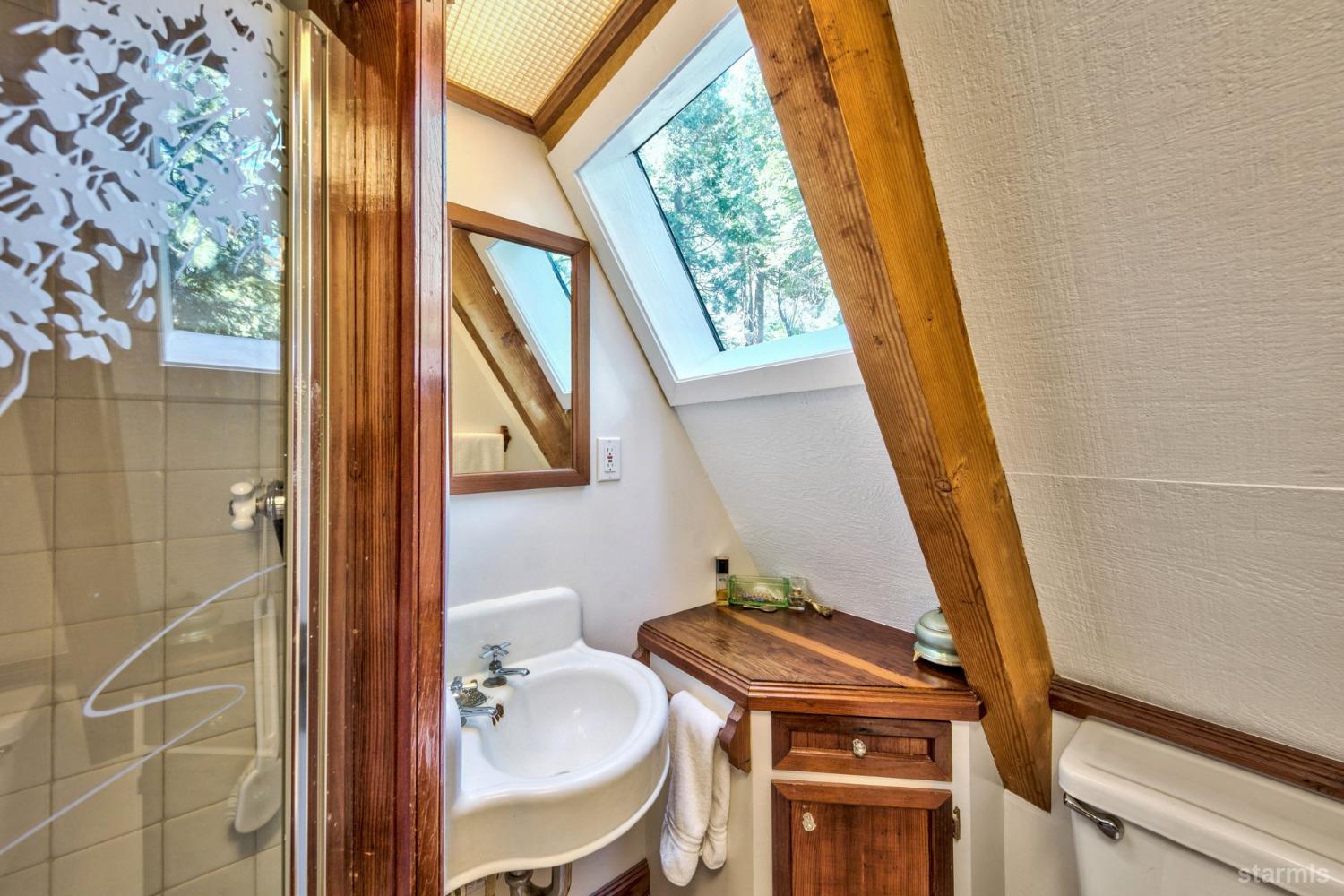 1085 Cooks Spur Road Twin Bridges, CA 95735 - Photo 26 of 30 a bathroom with a sink a toilet a mirror and shower