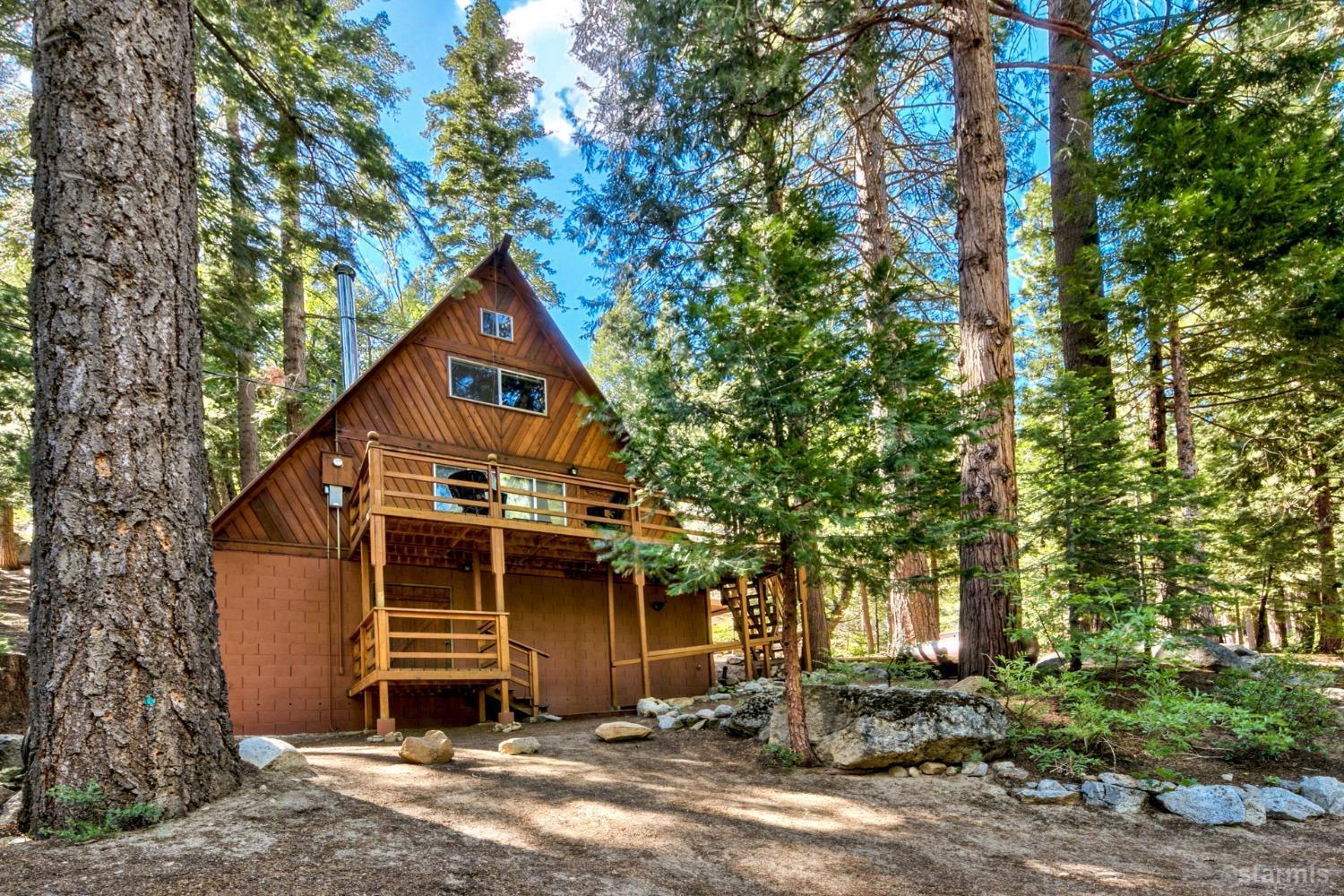 1085 Cooks Spur Road Twin Bridges, CA 95735 - Photo 3 of 30 a view of a barn house next to a yard with large trees