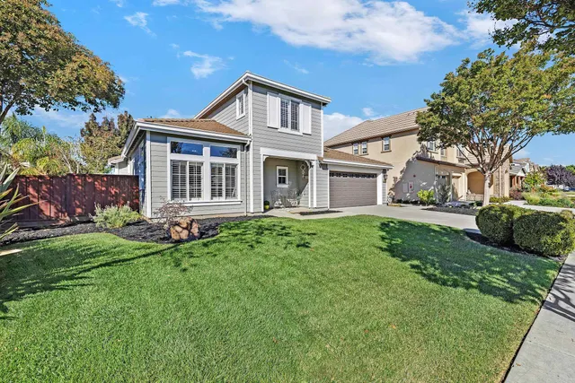 a front view of a house with a garden
