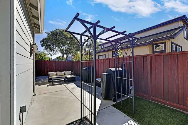 a view of a chairs and table in the back yard of the house