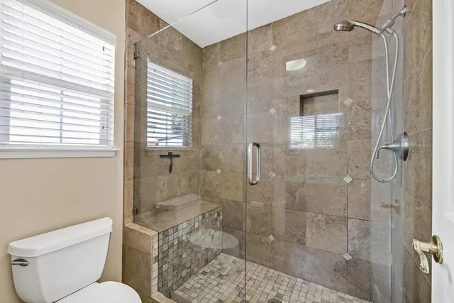 a bathroom with a toilet and shower