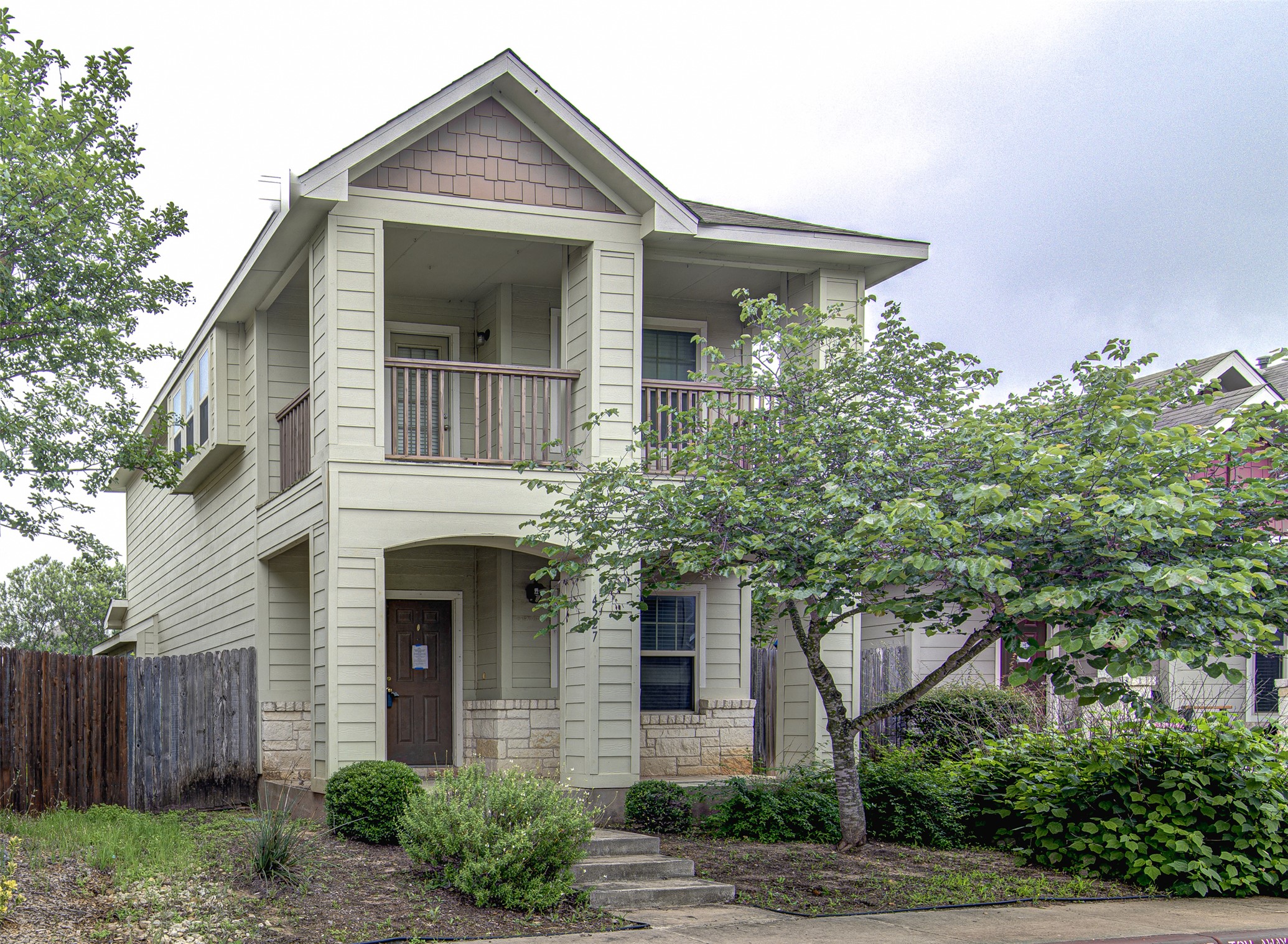 4527 Kind Way, Unit 231 Austin, TX 78725 - Photo 2 of 18 Two-story residence featuring light-colored siding and a stone facade foundation