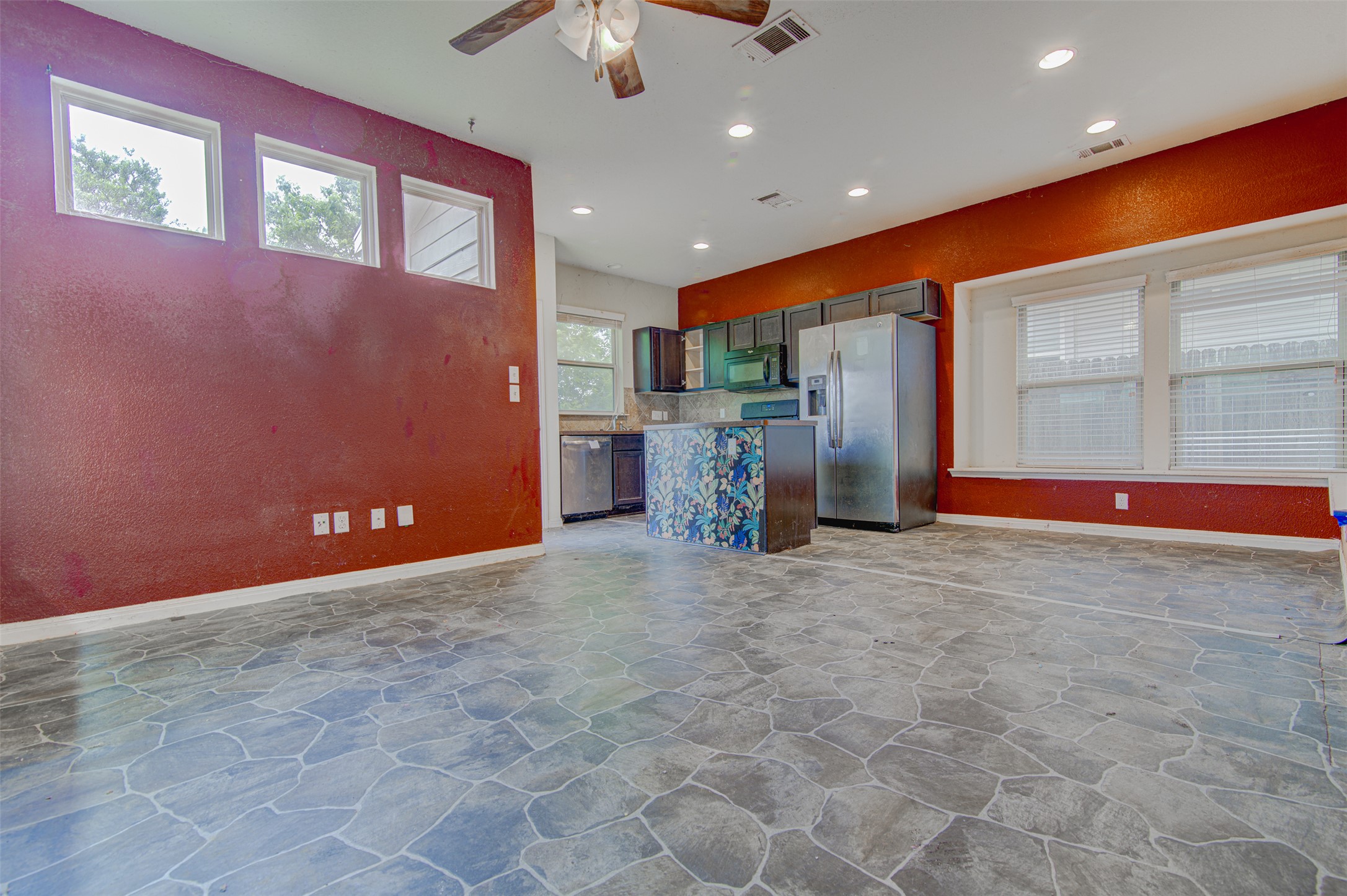 4527 Kind Way, Unit 231 Austin, TX 78725 - Photo 3 of 18 Open-concept living area with irregular stone-look flooring, a ceiling fan, and recessed lighting