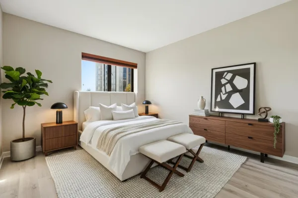 a bedroom with a bed and a potted plant