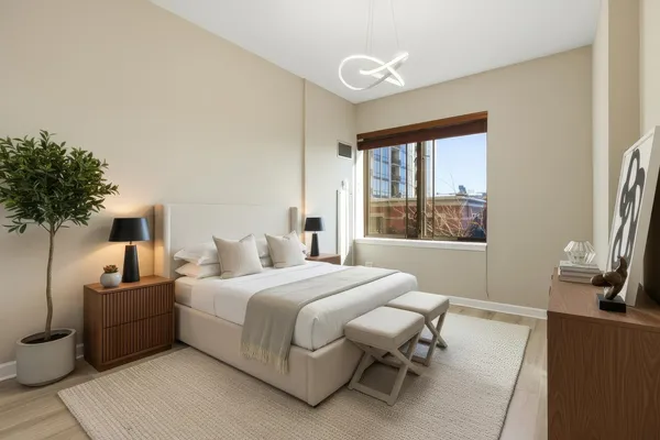 a bedroom with a bed and a large window