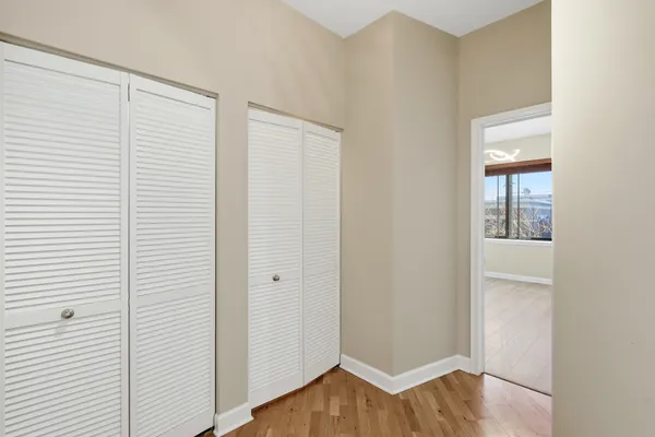 a view of empty room with wooden floor