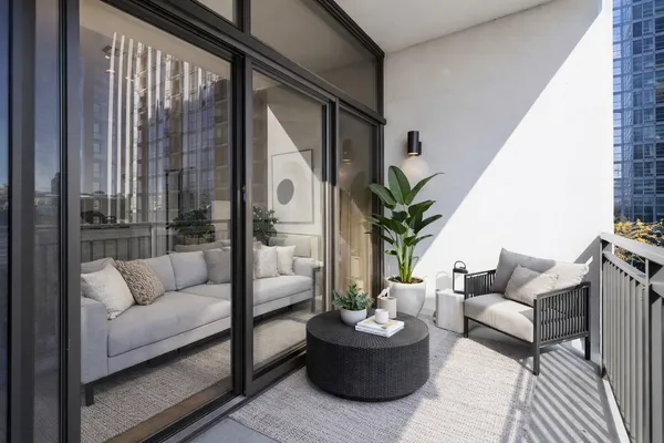 a living room with furniture and a potted plant