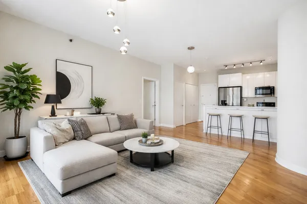 a living room with furniture and a wooden floor