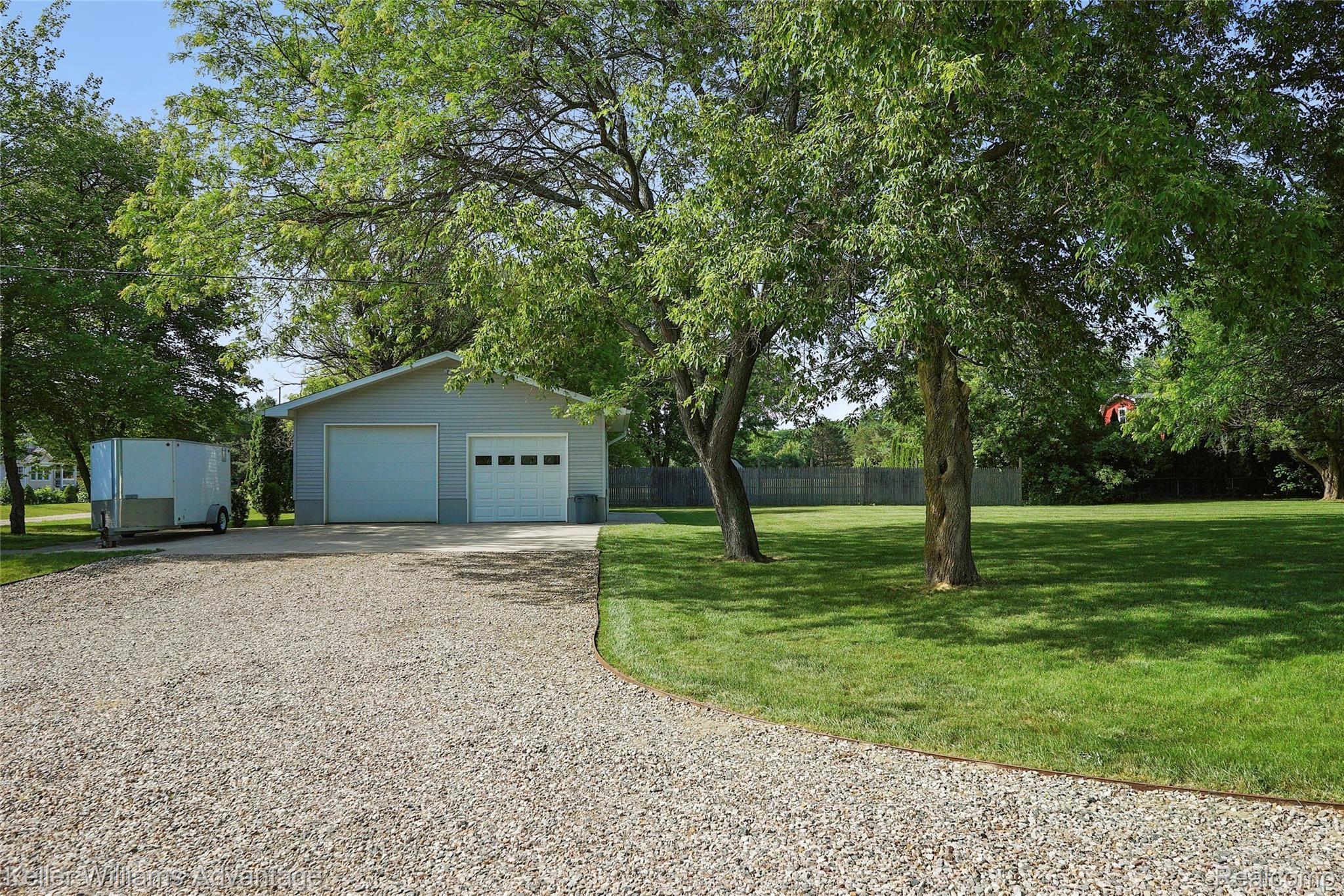944 Chase Lake Road Howell, MI 48855 - Photo 27 of 36 Beautifully maintained property, approaching 30x30 pole barn. Pole barn is heated and insulated, with 10-foot door and epoxy floors. It's immaculate!