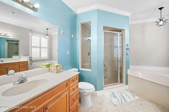 a spacious bathroom with a granite countertop sink toilet a large mirror a shower and a bathtub