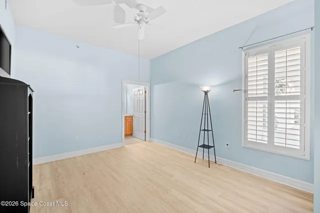 a room with a window and ceiling fan