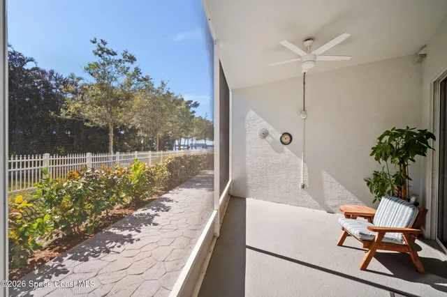 a swimming pool with outdoor seating and plants