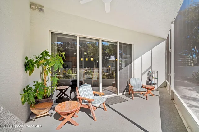 a building outdoor space with patio furniture and potted plants