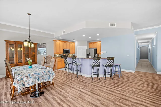 a dining room with furniture and wooden floor