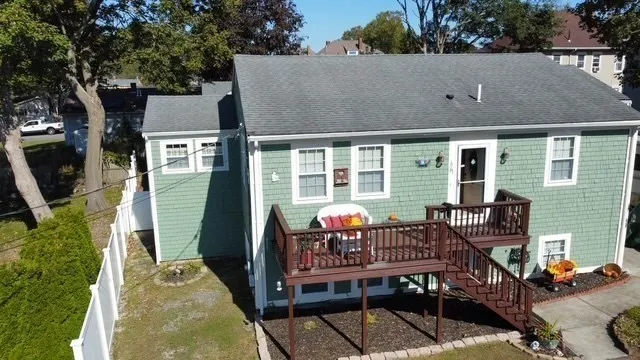 aerial view of a house with balcony and furniture