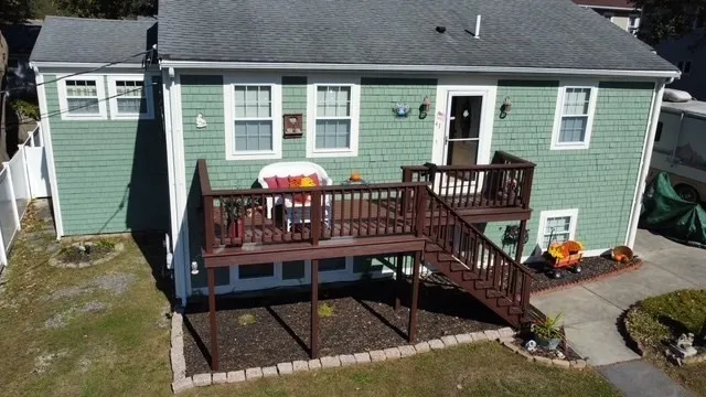 a view of a balcony with wooden floor and stairs