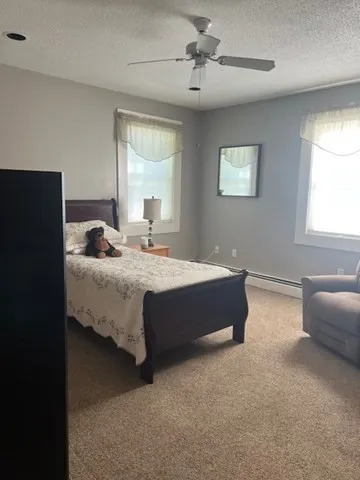 a bedroom with bed and window