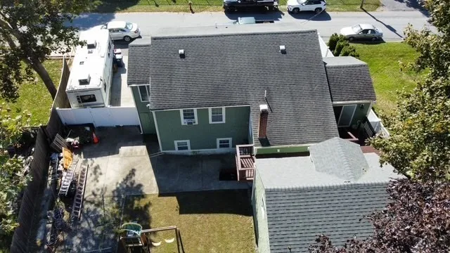 an aerial view of a house with a yard