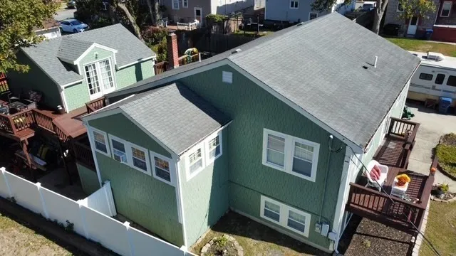 an aerial view of a house with outdoor seating