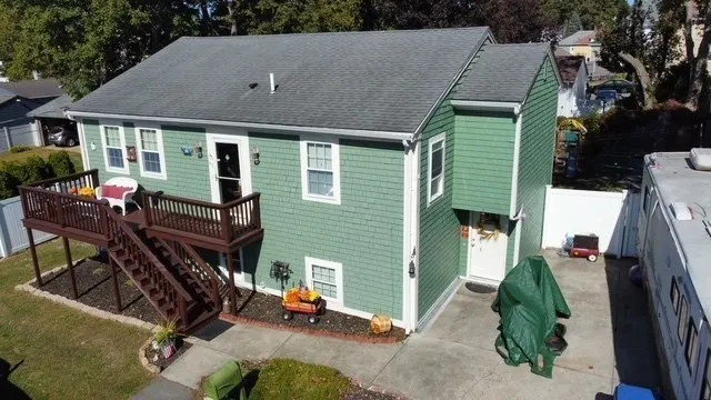 a view of a house with backyard and deck