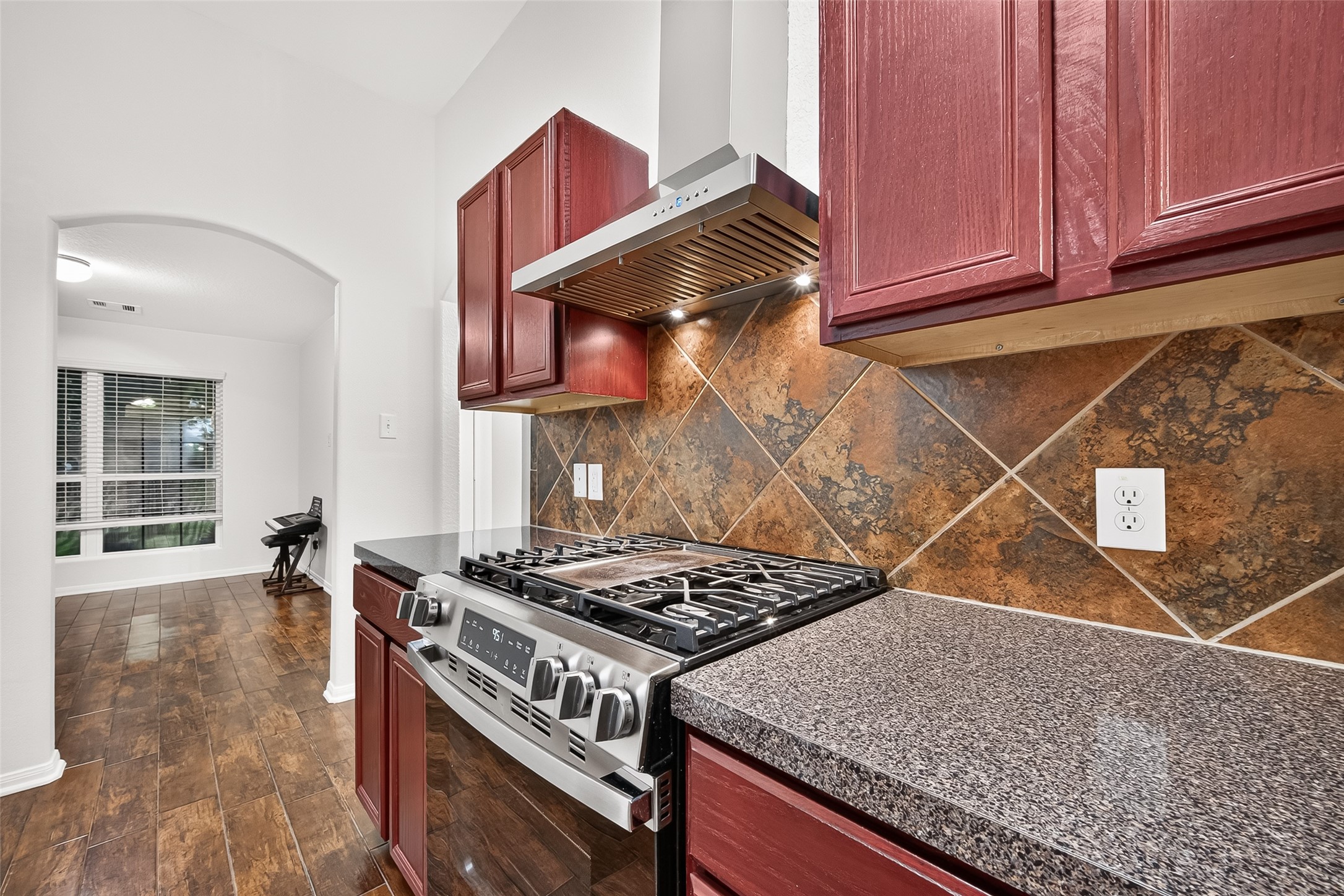 3155 View Valley Trail Katy, TX 77493 - Photo 22 of 50 Close-up of the high-end gas range and beautiful stone backsplash, perfect for the home chef.