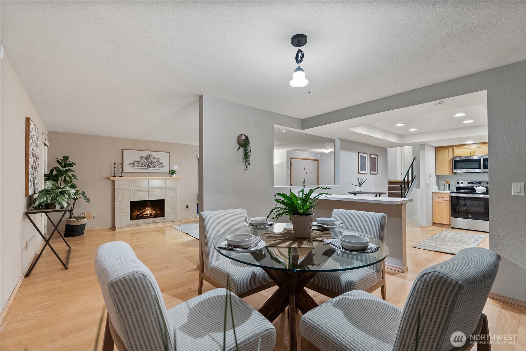 15618 Southeast 174th Street Renton, WA 98058 - Photo 7 of 28 a view of a dining room with furniture and a fireplace