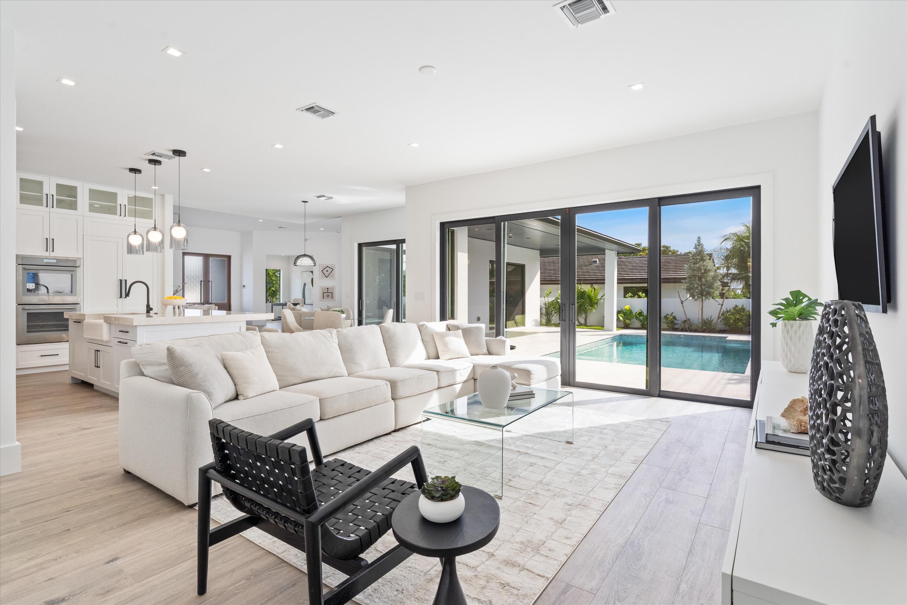 4451 Northeast 27th Terrace Lighthouse Point, FL 33064 - Photo 13 of 38 a living room with furniture and a floor to ceiling window
