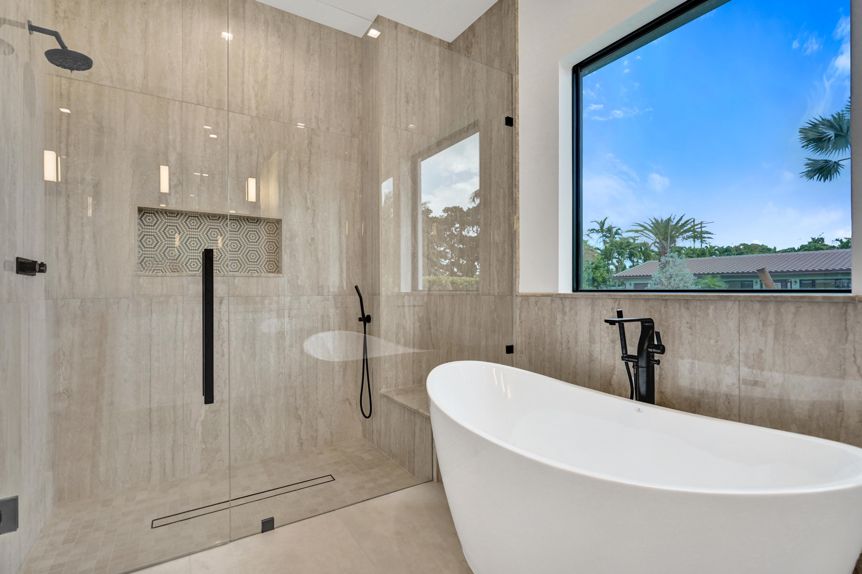 4451 Northeast 27th Terrace Lighthouse Point, FL 33064 - Photo 18 of 38 a bathroom with a bathtub and shower