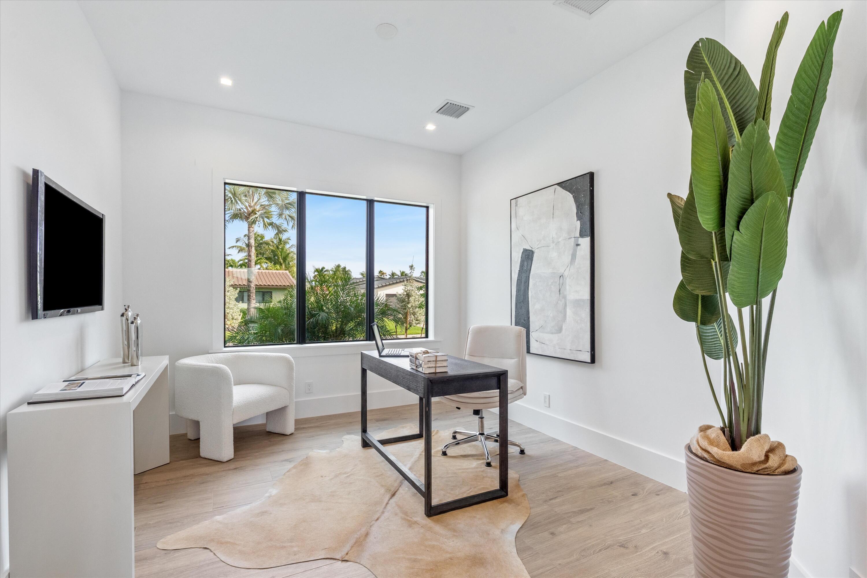 4451 Northeast 27th Terrace Lighthouse Point, FL 33064 - Photo 19 of 38 a living room with furniture a potted plant and a window