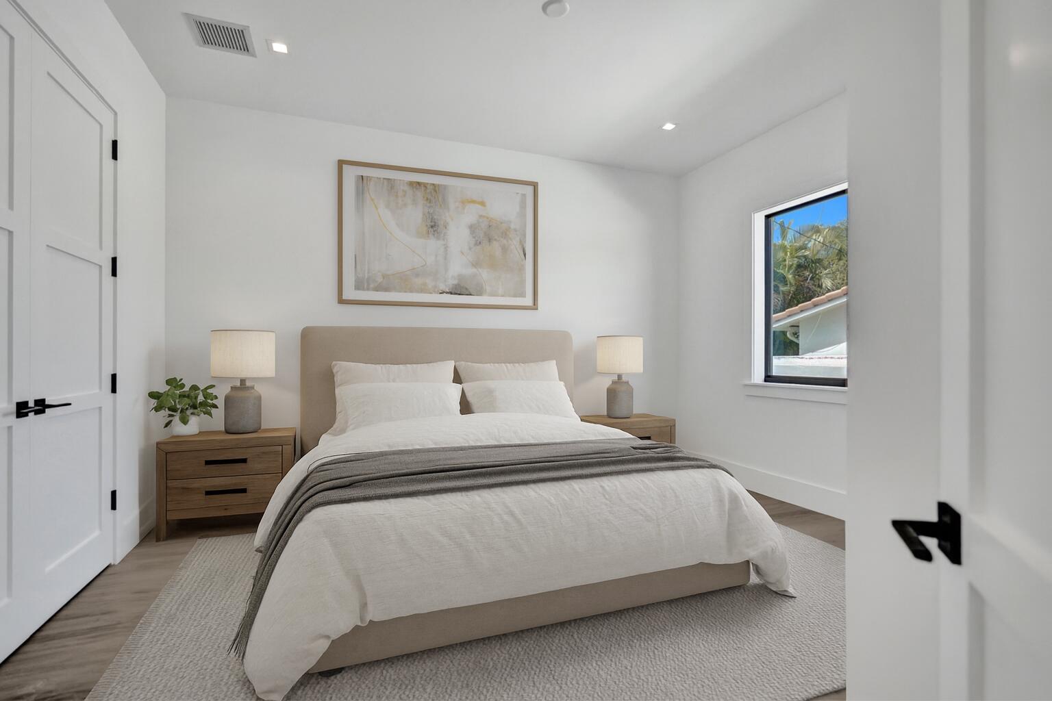 4451 Northeast 27th Terrace Lighthouse Point, FL 33064 - Photo 22 of 38 a bedroom with bed and wall painting